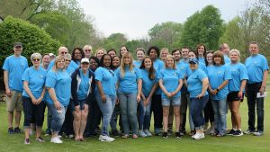 YOC staff members pose at the 2019 Golf Outing, smiling at the camera.