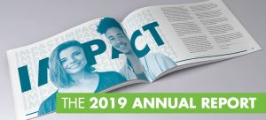 The 2019 Annual Report, laid out to a spread of two pages where you see two smiling faces and the word "IMPACT".